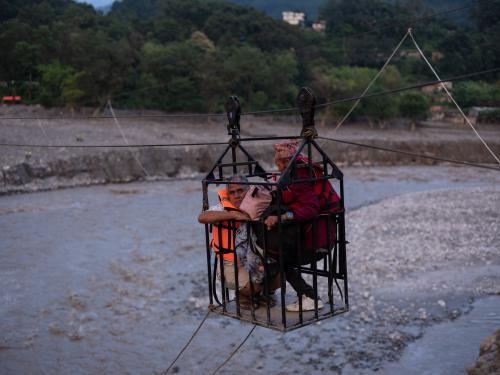People cross the Trishuli River in a Tuin the only way possible, a cage suspended from a makeshift zip line, in Nuwakot district. Floods damaged bridges connecting Trishuli Bazar and Bidur